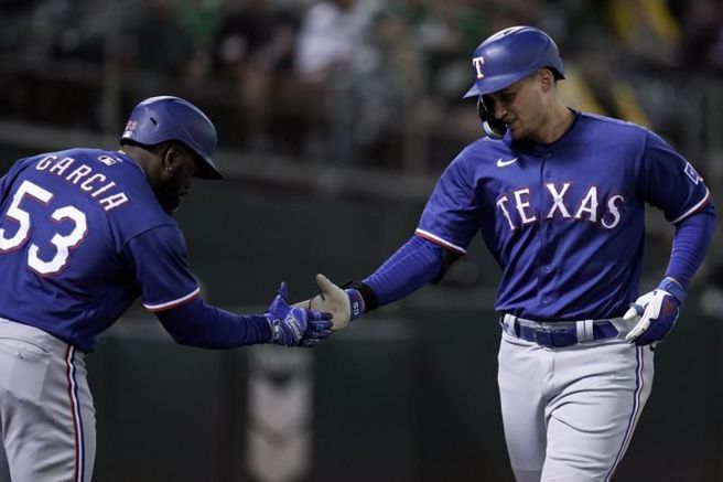 游骑兵游击手席格(右)与队友庆祝得分。（美联社）