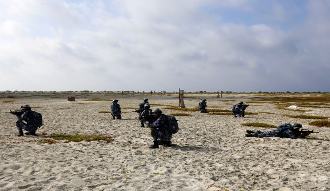 西沙群岛西南端的中建岛位于远东通往东南亚的海空要道上，北距海南岛300多公里，图为官兵在白沙滩上训练的资料照。（中新社）