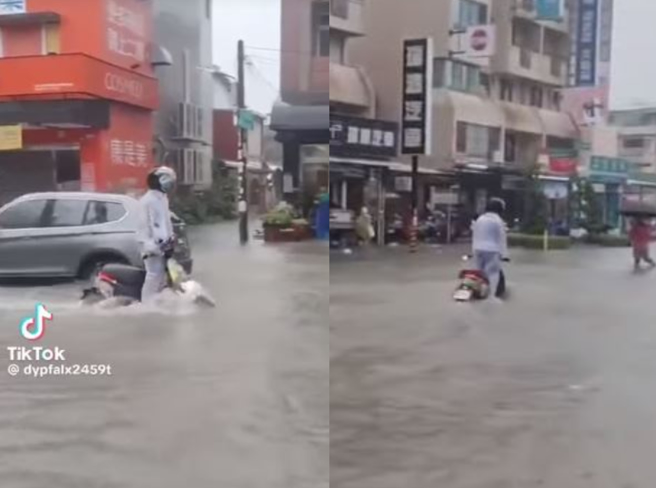 高雄強降雨馬路變河道，騎士站立乘「水上摩托車」狂飆引熱議。（翻攝自影片）