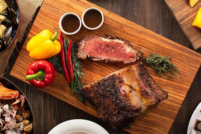 招牌「炉烤美国肋眼牛排」以秘制酱料调味腌制，透过低温炉烤5至7分熟，口感软嫩无比。(台北新板希尔顿酒店提供)