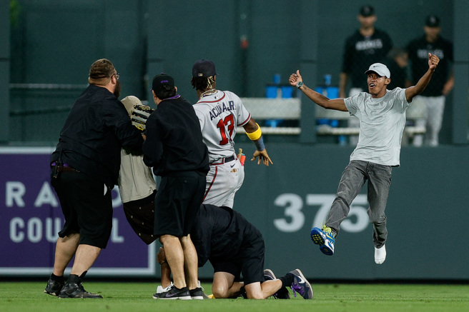 另一位球迷（右）狂奔而来，直朝小阿库尼亚的方向扑去。（路透）