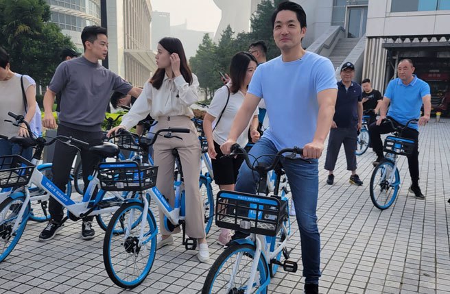 訪上海行程最後一天，台北市長蔣萬安仍起了大早，與上海當地的台灣青年一同騎乘共享單車。（丁上程攝）