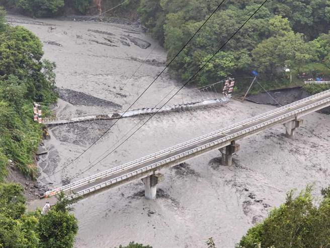 布拉鲁桥一旁情人吊桥遭洪水冲毁，因布拉鲁桥桥头边坡崩落，仁爱乡公所下午4时预警性封桥。（仁爱乡公所提供／杨静茹南投传真）