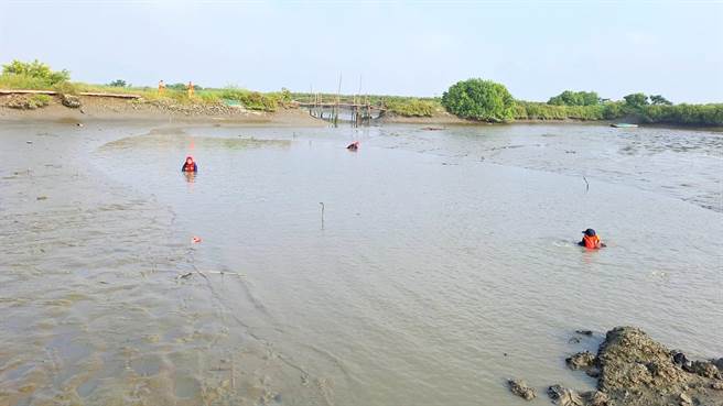 搜救人员以趴伏姿势，搭配霸王鉤来回移动寻找移工下落，目前还在搜索中。（嘉义县消防局提供／吕妍庭嘉义传真）