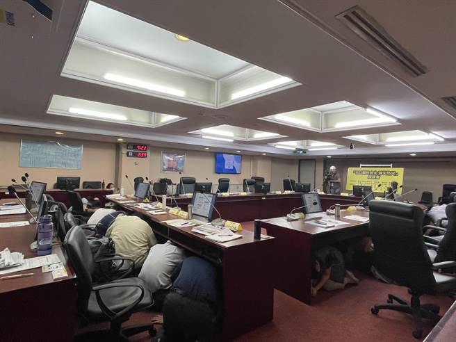 「921韧性台北 减灾防灾」座谈会进行时，921模拟警报响起，在场不论议员、专家或市府官员全数躲在桌子下演练。（刘彦宜摄）