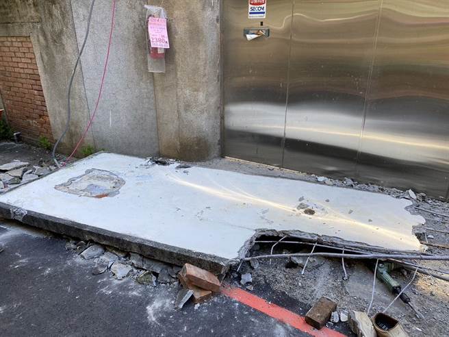 长逾1.5公尺、重达数百公斤的水泥砖墙倒塌，不偏不倚压中吴男下半身，消防人员合力抬起砖墙，协助吴男脱困。（新北市消防局提供）