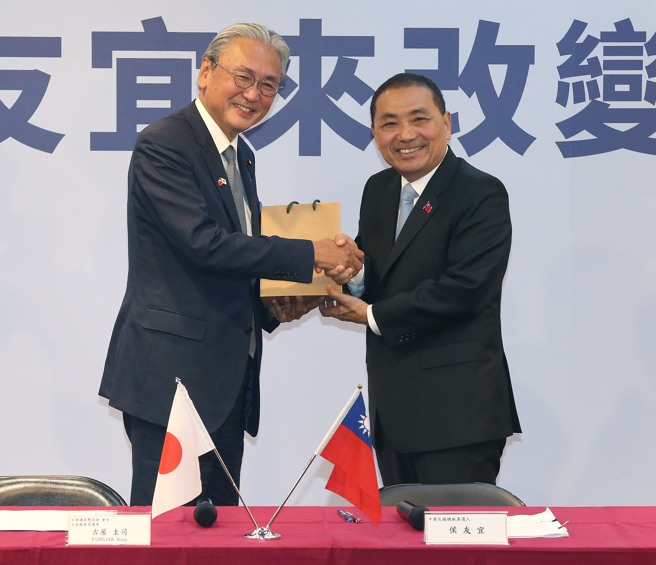 日华议员恳谈会9日拜会国民党总统参选人侯友宜，恳谈会会长古屋圭司（左）与侯友宜（右）互换礼物。（陈君玮摄）