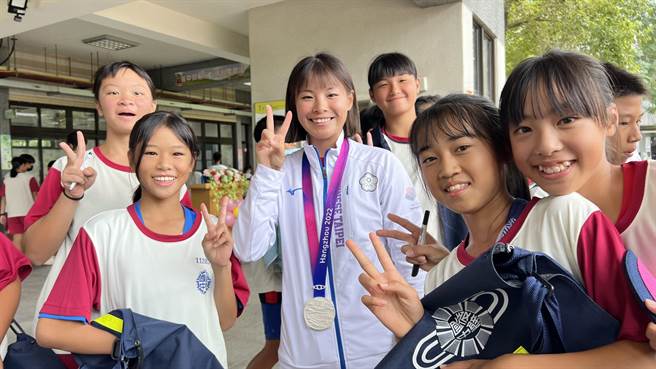 黃詩媛（左三）等5名亞運選手16日回到台南後壁國中母校時，受到學弟妹夾道歡迎。（張毓翎攝）