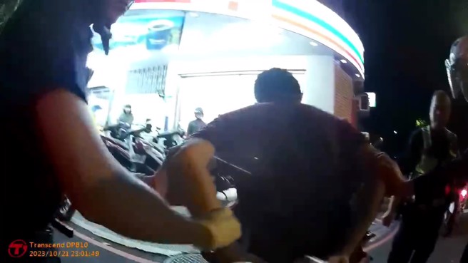 新北市1名39歲趙姓男子，持折疊刀阻擋員警行車，遭員警上銬逮捕。（翻攝畫面）