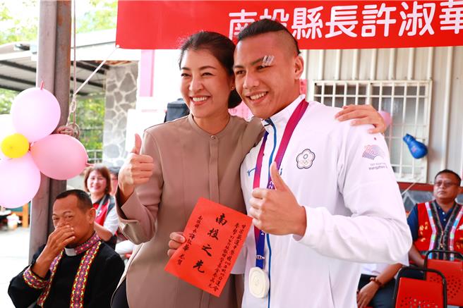拳击国手甘家葳（右）在亚运浴血奋战，因伤无缘争夺金牌，仅获银牌，其奋战精神令南投县长许淑华（左）钦佩，亲自颁发奖励金。（南投县政府提供／杨静茹南投传真）