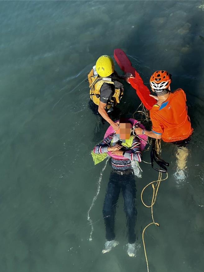 淡水釣客不慎落水，騎單車路過的民眾跳河搶救，警消到場救援發現釣客血氧過低緊急送醫。（翻攝畫面）