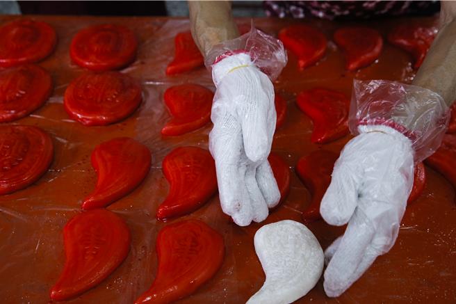 獅潭鄉新店社區27日在義民廟舉辦打新丁粄活動，桃子形狀的新丁粄為生女孩專用。（黃子明攝）