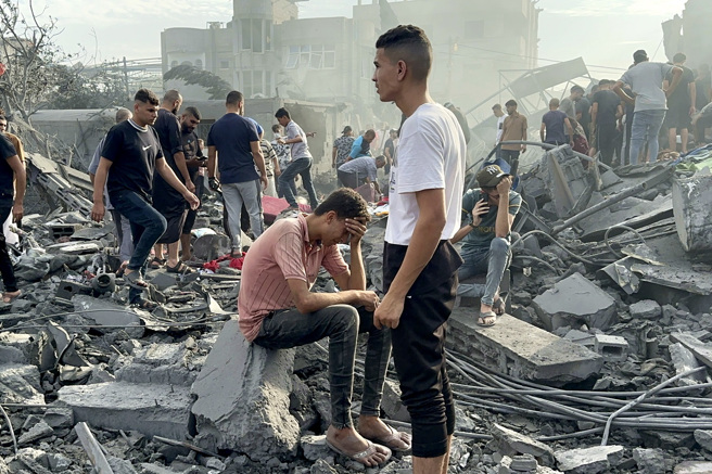 外洩的以色列報告指出，以色列計畫將230萬加薩居民遷往埃及西奈半島北部。圖為加薩中部努薩拉特（Nusseirat）難民營被轟炸後，居民在瓦礫堆中尋找生還者。（圖／美聯社）