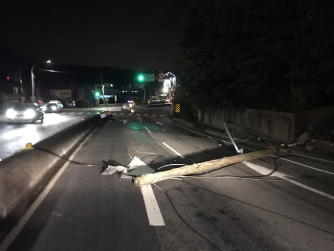 新北市淡水區淡金路與興仁路口29日凌晨3時30分許，發生一起自撞車禍，1輛自小客車疑車速過快失控自撞路旁商家石敢當及電桿。（圖／警方提供）