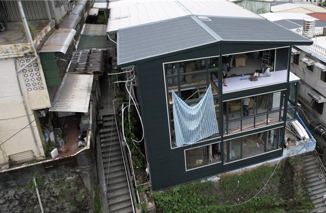 基隆市东光路11巷内有一处民宅（黑色），遭检举为违建，市府已张贴勒令停工，屋主却持续施工。市府已要求屋主11月18日前限期自行拆除，否则将由市府强制拆除，且费用由违建人负担。（里长翁诚锺提供／张志康基隆传真）