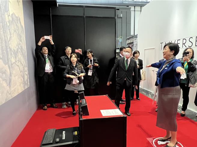 东京都知事小池百合子(右)在日本台湾形象馆数位故宫展区，下场挥动身体亲身体验栩栩如生画景，露出开心笑容。(王玉树摄)