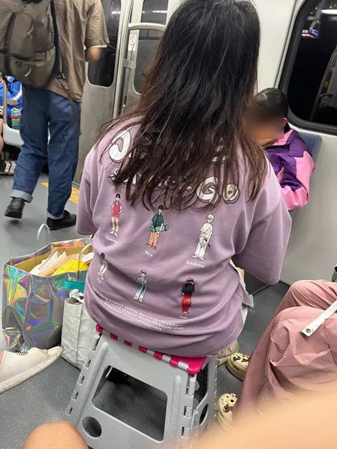 女子搭区间车，自备折迭椅，直接坐在走道上。（翻摄Dcard）
