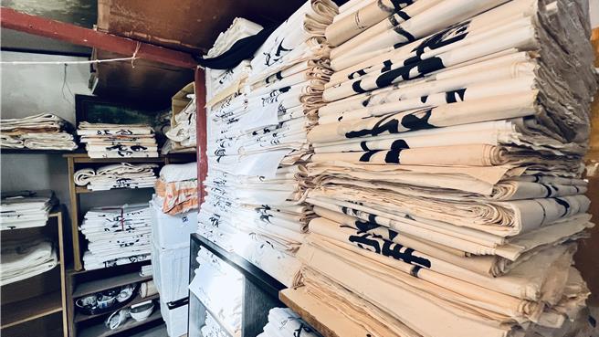 10坪不到的小小工作室，疊滿了劉載福上千幅的書法作品。（張毓翎攝）