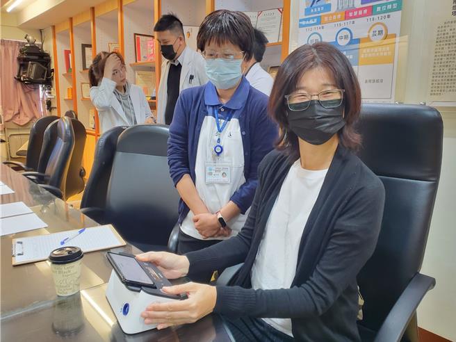 台大云林分院以移动式心电图仪下乡为65岁以上长者筛检是否罹患心房颤动，只要双指按30秒即可判读，图为示范。（周丽兰摄）
