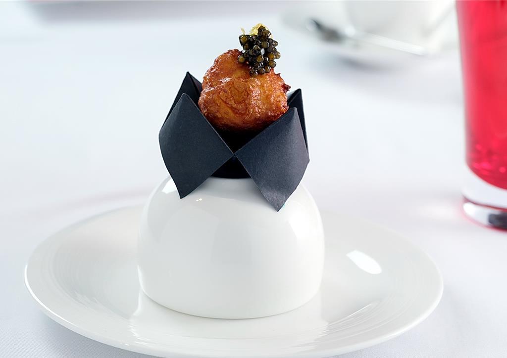 〈檸檬奶油配魚子醬〉是以檸檬奶油凍為「炸泡芙」內餡，再以Royal Cristal Caviar魚子醬裝飾，為甜鹹交織的輕奢級開胃小食。圖／台北遠東香格里拉飯店提供