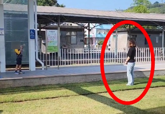 家長帶小孩在高雄輕軌的軌道上違規跨越拍照。（翻攝爆料公社）