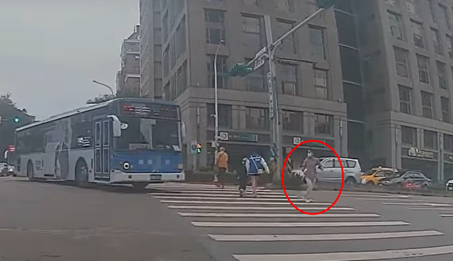 有行人綠燈走在斑馬線上，沒想到公車轉彎未禮讓，嚇得他拔腿快跑險被撞飛。（ 圖／ 翻攝自「WoWtchout-地圖型行車影像分享平台」）
