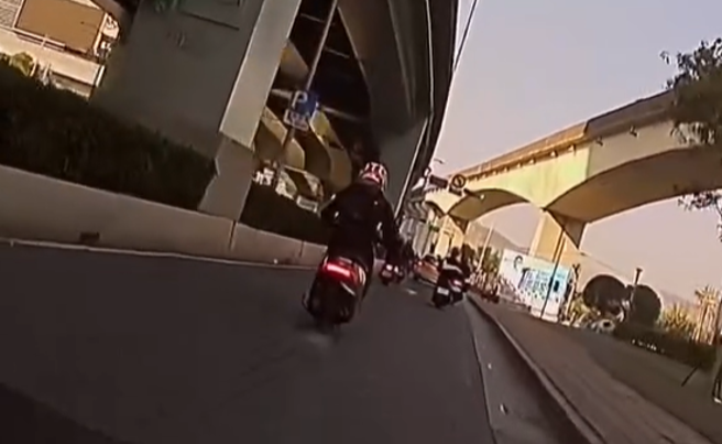 有女骑士发现前方Gogoro电动车突然打滑，一看原来是车牌卷入后车轮卡死。（图／翻摄自爆料公社）