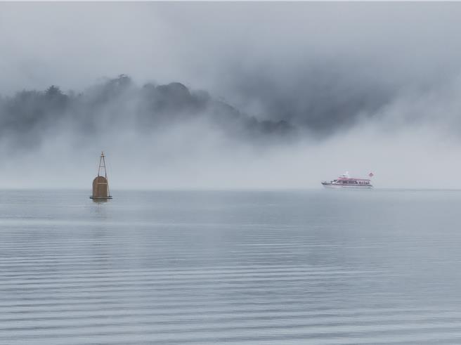 鋒面過境冷空氣南下，日月潭雲霧飄渺似潑墨山水畫，遊艇緩緩划過湖面掀起圓弧波紋。（民眾提供／楊靜茹南投傳真）
