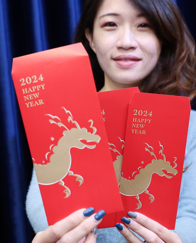 总统府27日举行「民国113年总统、副总统春联、红包袋、福袋」公布记者会，展示龙年红包袋呈现金龙昂首阔步的姿态，传递出祝福和进步向前的意象。（陈俊吉摄）