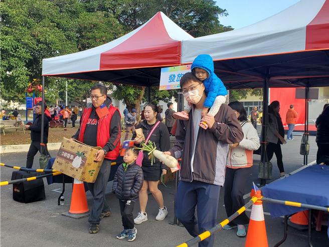 参加元旦升旗民眾都致赠白萝卜，象徵好彩头。（周丽兰摄）
