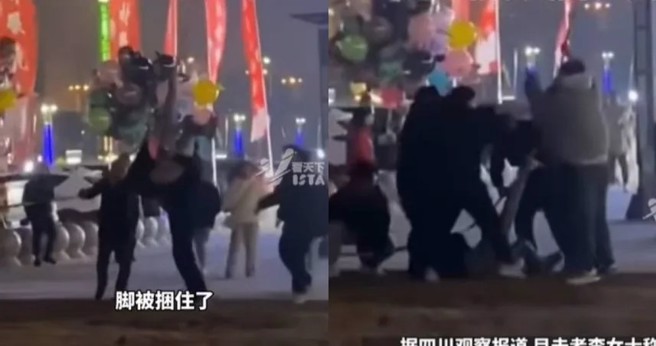 男子头下脚上倒挂升空，民眾赶紧将人救下。（图/翻摄九派新闻）