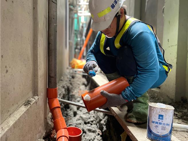 施工人员将生活污水管接入下水道。（新北市水利局提供）