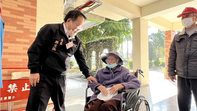 台南市柳營區102歲人瑞陳劉鴛鴦（中），一早在家人陪同下前往投票，柳營區長顏文穗（左）特別前來打招呼問暖。（張毓翎攝）