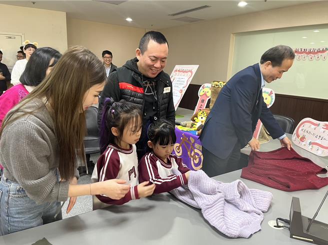 家长与孩子们学习如何整理收纳衣服。（陈梦茹摄）