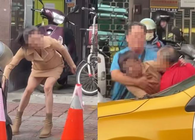 女子和运将在街头起争执，还拿着三角砖、大锁就要往运将砸，所幸被一旁的蓝衣男子组拦、拉开。（图／翻摄自脸书爆料公社公开版）
