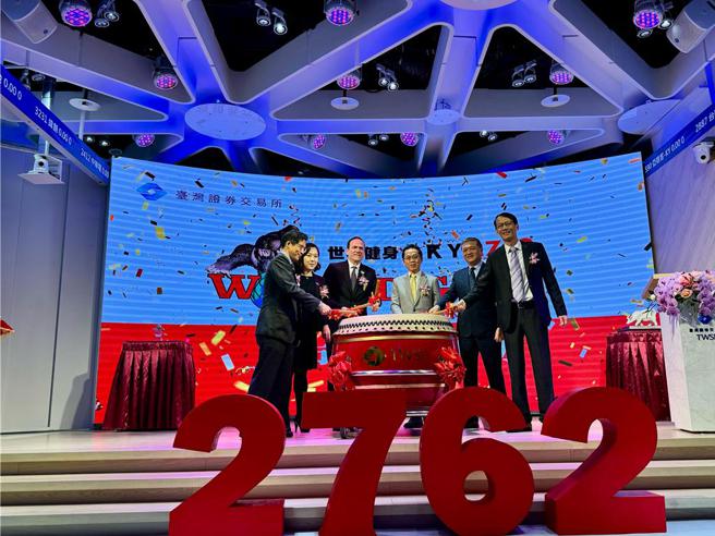 世界健身-KY24日掛牌上市，董事長柯約翰（左3）等人親自出席掛牌典禮，並擊鼓慶祝。（圖／世界健身）