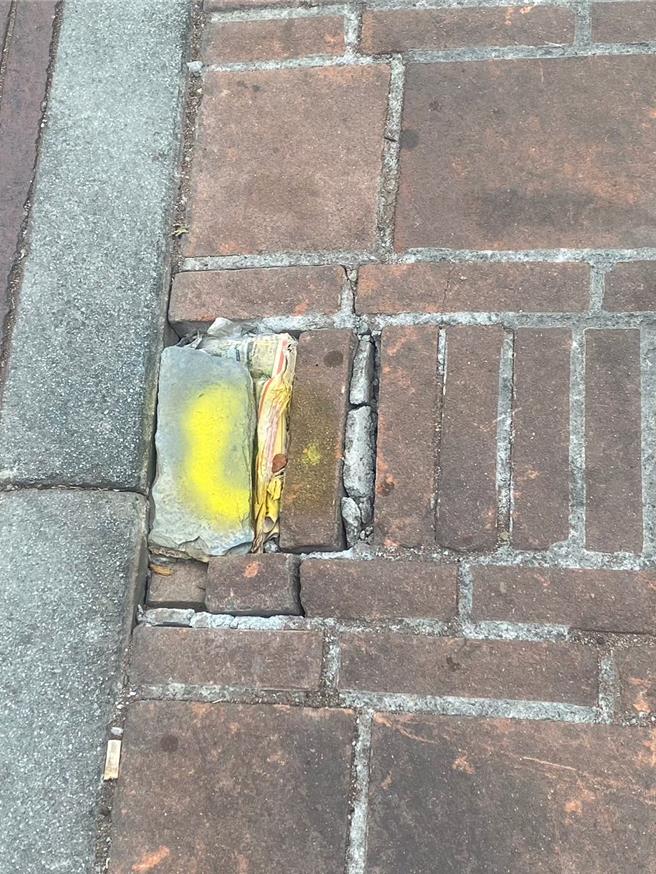 台中市雾峰第一公有市场内的「阿罩雾旧街」6年前整修铺上红砖，盼重现老街风华，不料长久下来，红砖不耐车辆辗压破损，以柏油填补如同贴满「狗皮药膏」，来不及铺设之处甚至有人放上砖头报纸铺设。（台中市议员张芬郁提供／潘虹恩台中传真）