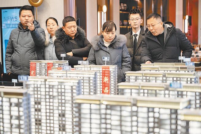 上海推出優化住房限購政策，連續繳納社會保險或個人所得稅滿5年以上的非本市戶籍居民，可在外環以外區域限購1套住房。圖為民眾在展售中心看房。（中新社）