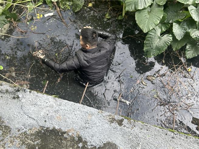 吳姓男子身陷排水溝，員警協助他脫困。（警方提供）