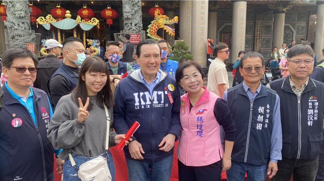 前总统马英九（左三）3日到潭子区潭水亭观音妈庙，亲送其亲笔撰写的龙年春联，吸引民眾开心领取、合照。（张妍溱摄）