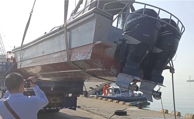 海巡署今日下午出動起重機，將翻覆的陸籍快艇吊起進行勘驗，結果發現該快艇配有「雙舷外機」的超強馬達，比一般船舶速度更快，裝備了得。（圖／民眾提供）