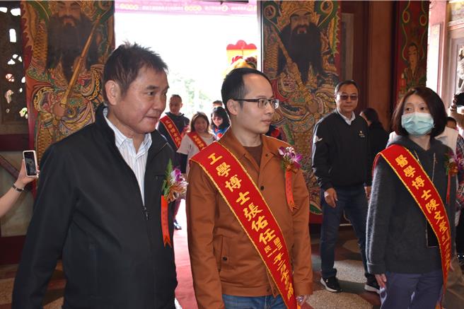 头份市永贞宫士子开中门24日登场，苗栗县长锺东锦陪着新科博士欢喜过中门。（谢明俊摄）