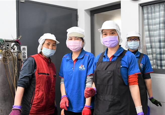 小萍（左2）表示同事们都很友善，不仅有条理地指导剥虾技巧，还耐心地聆听她的问题，让她对剥虾工作快速上手。（吕妍庭摄）