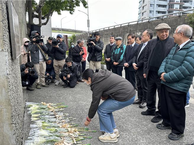 政治受难者、家属代今午在不义遗址牌面献花。（高钧麟摄）