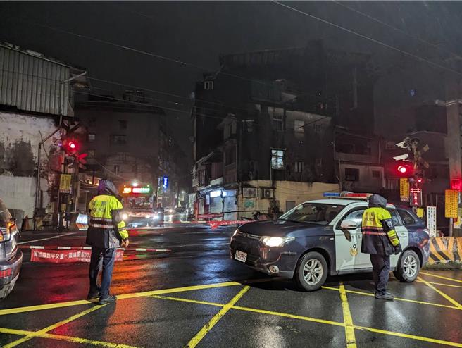 基隆八堵分驻所2月29日晚间10时许左右，突有一辆小货车不明原因撞进派出所内，造成员警1死1伤。而嫌犯简男逃逸至暖暖火车站也遭撞死。图为警方封锁平交道处理事故。（张志康摄）