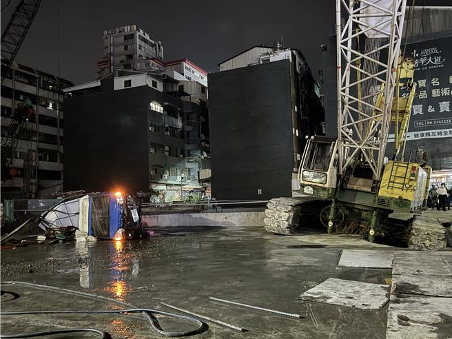 吊车救完陷落坑洞的货车后，吊车也陷入坑洞。（曹婷婷摄）