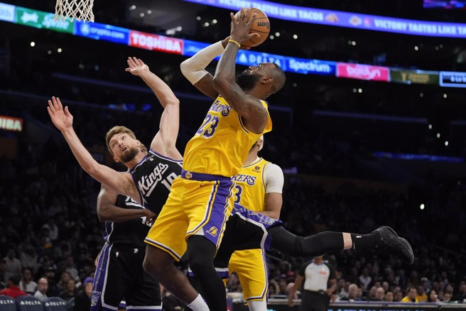 詹姆斯切入上篮撞翻沙波尼斯。(美联社)