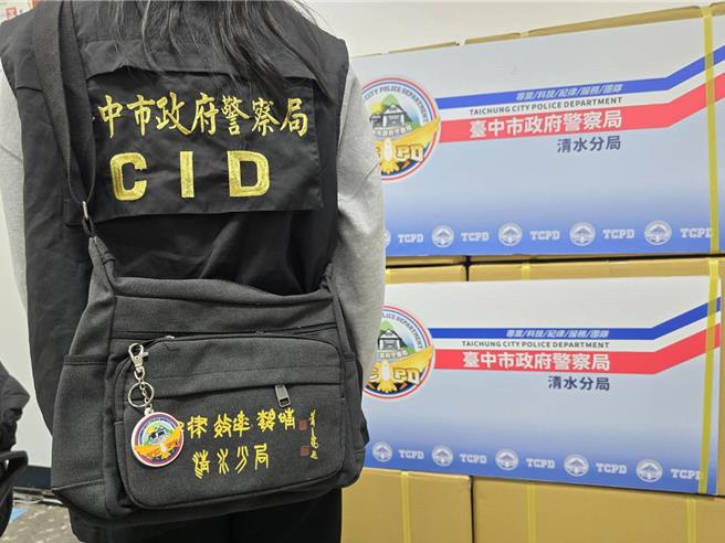 清水警分局派員背著印有「紀律 效率 熱情 清水分局」黃色字樣的黑色側背包，包上掛有新標誌「鑰匙圈」。（清水警分局提供／張妍溱台中傳真）