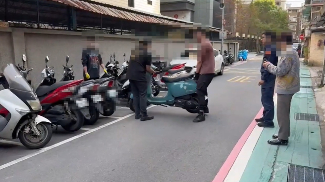 在警方见证陪同下，王阳明公司3名壮丁，将乱停的机车，移至路边停车格。（翻摄画面）