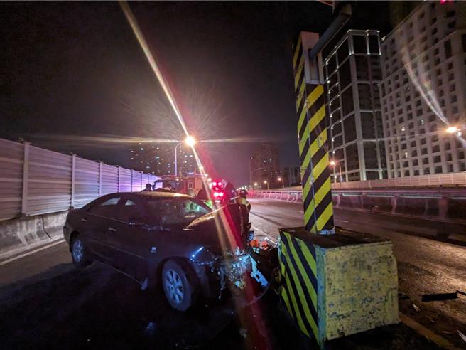 轿车自撞测速杆。（新北消防局提供／张铠乙新北传真）